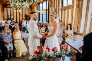 Smiling couple during a civil weddings ceremony with family and friends
