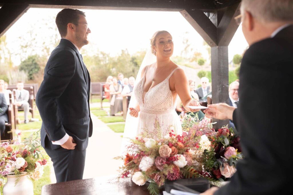 Bride receiving her promises during the ceremony at The Channels Estate, Essex.