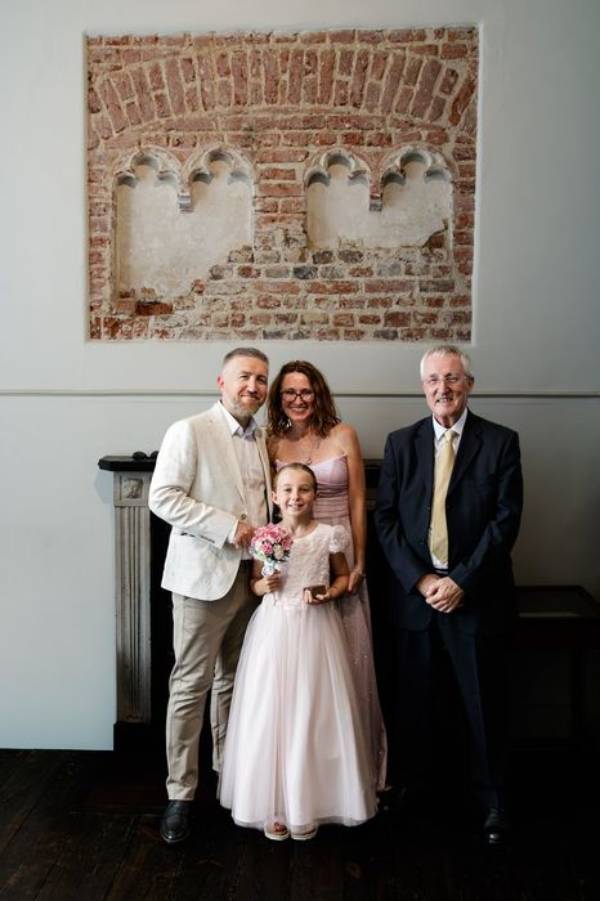 A couple with their daughter as flower girl and celebrant prior to their Essex vow renewal.